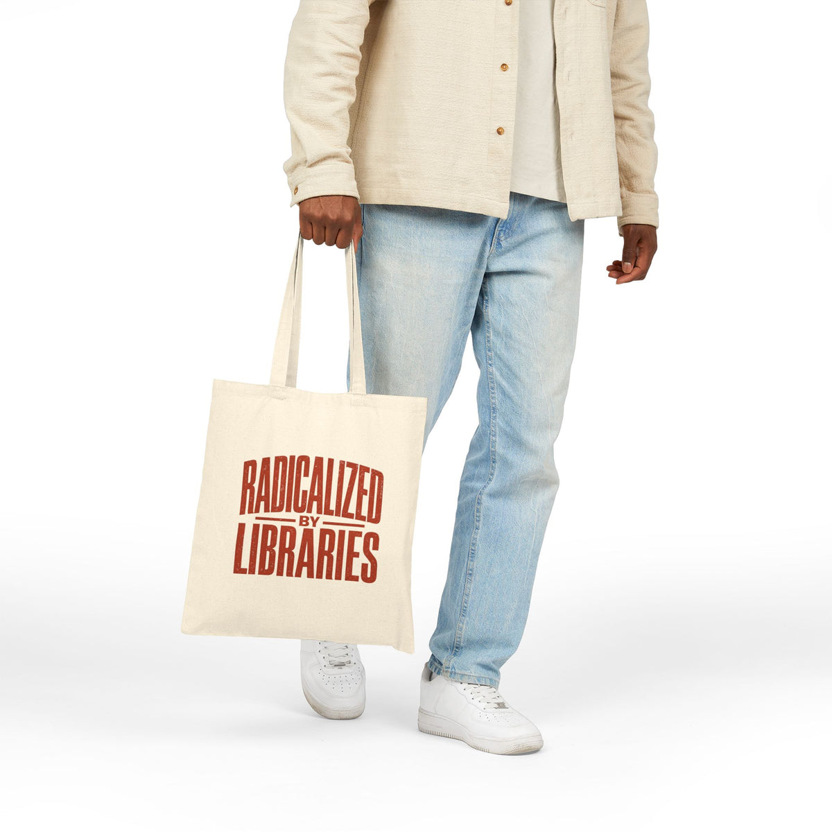 Person holding Radicalized by Libraries tote
