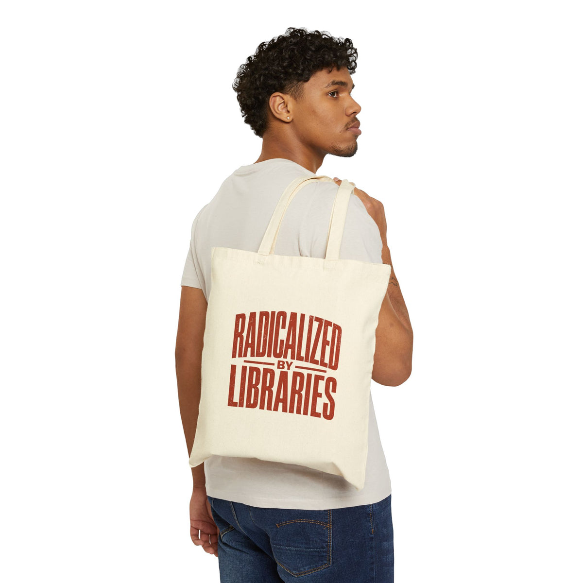 Man carrying a tote bag with a Radicalized by Libraries word design on a white background