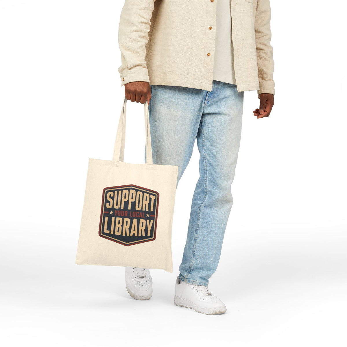 Person carrying a tote bag with the phrase Support Your Local Library graphic
