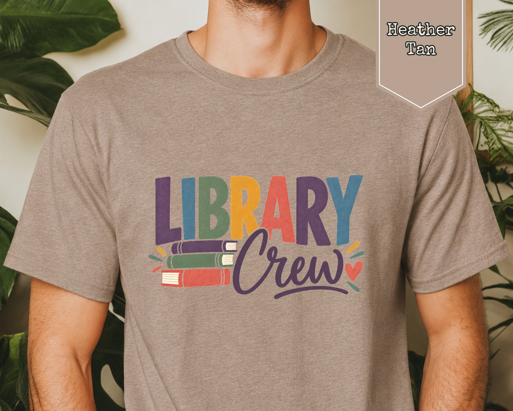 Person wearing unisex Library Crew librarian t-shirt in a library setting.