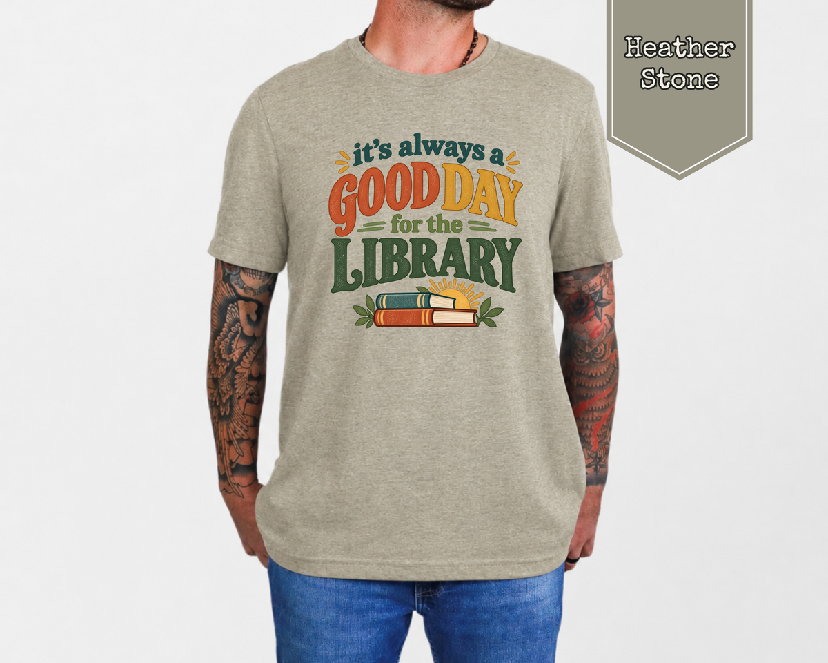 Woman wearing Heather Mustard Good Day for the Library retro librarian graphic t-shirt in cozy reading room.