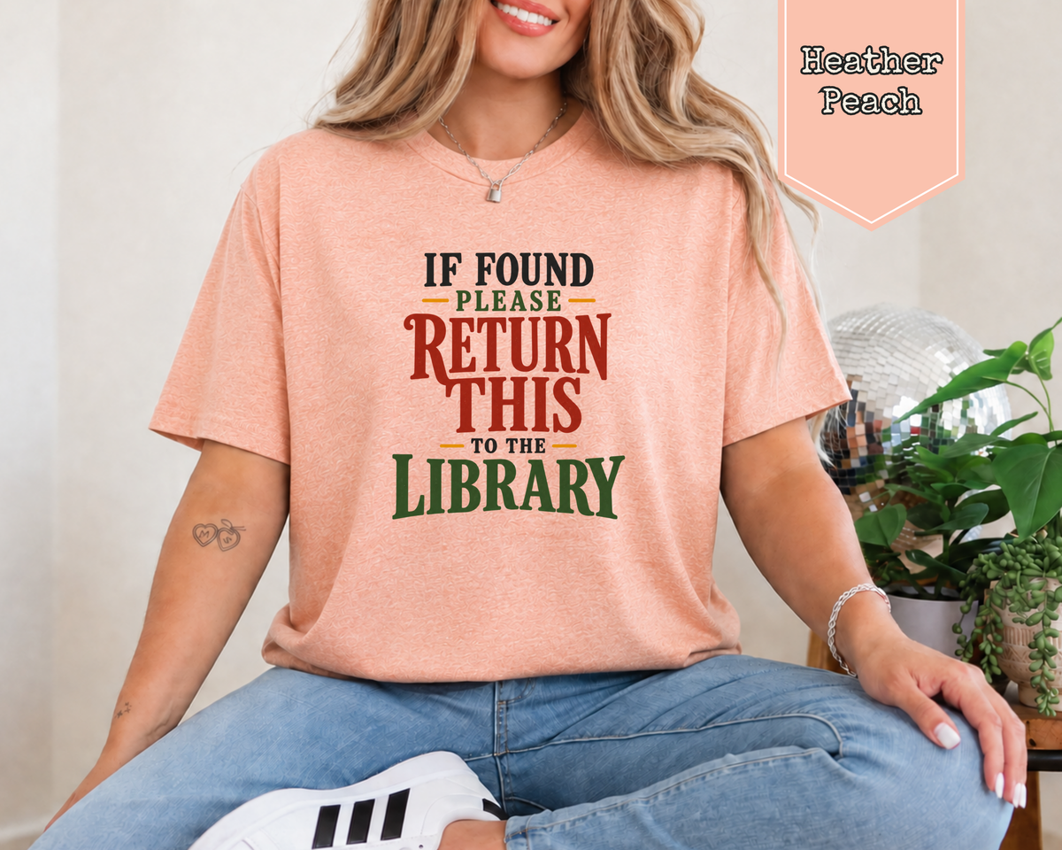 Person wearing Heather Clay If Found Please Return to the Library shirt.