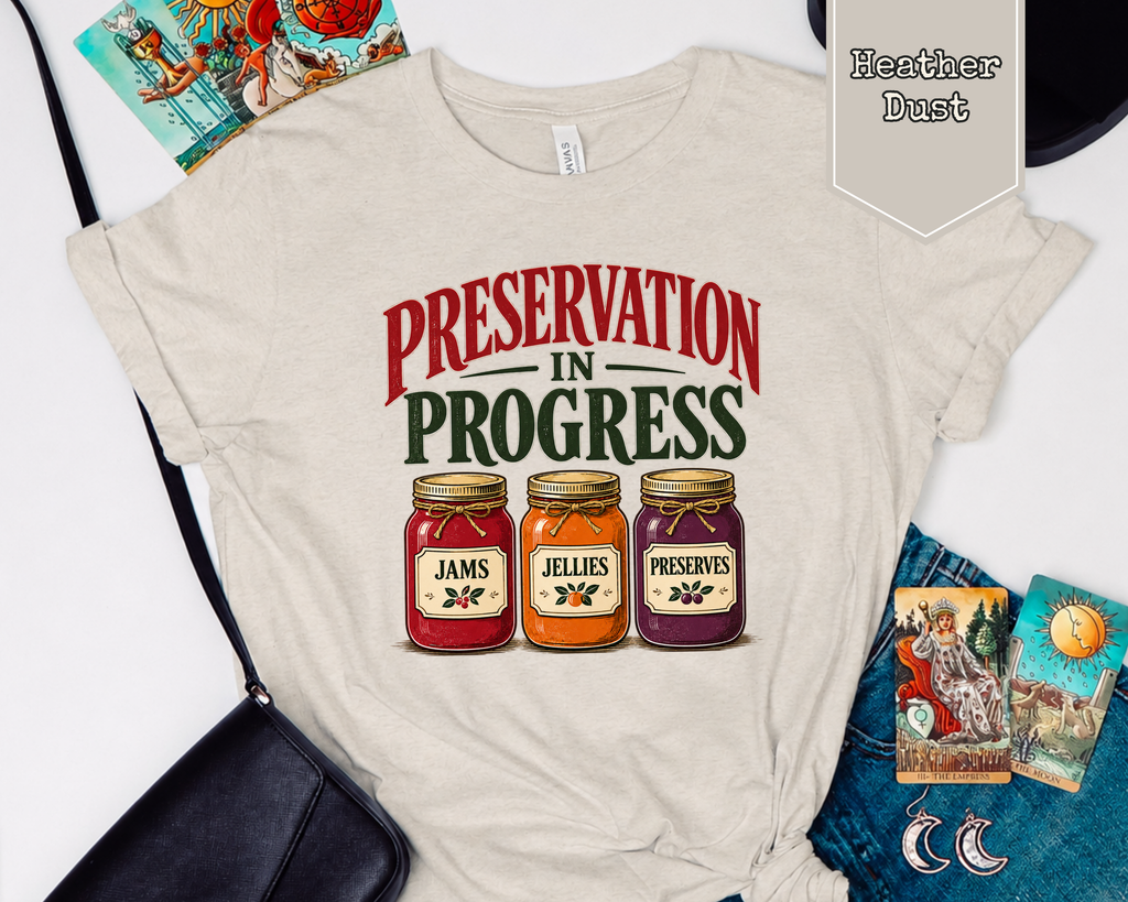 Folded Preservation in Progress archivist tee styled flat with vintage archival tools and books.