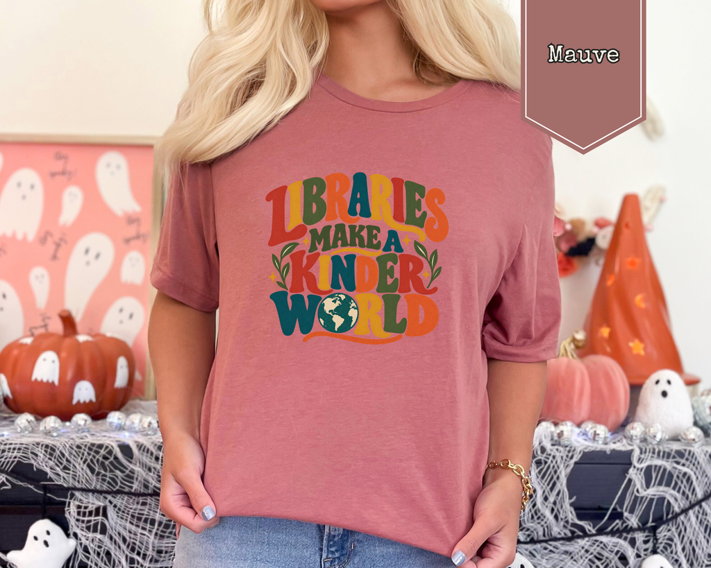 Person wearing Heather Prism Natural Libraries Make a Kinder World unisex graphic t-shirt.