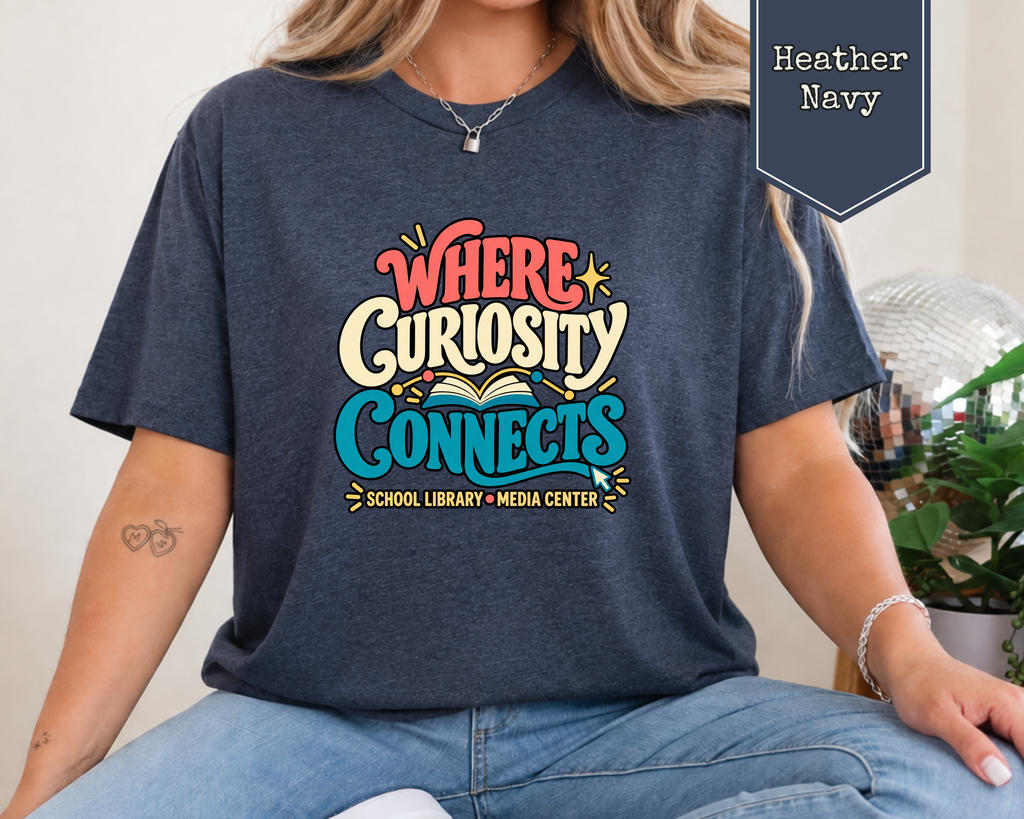 Woman wearing Heather Dust Where Curiosity Connects retro school librarian graphic tee with 1970s typography and open book artwork.