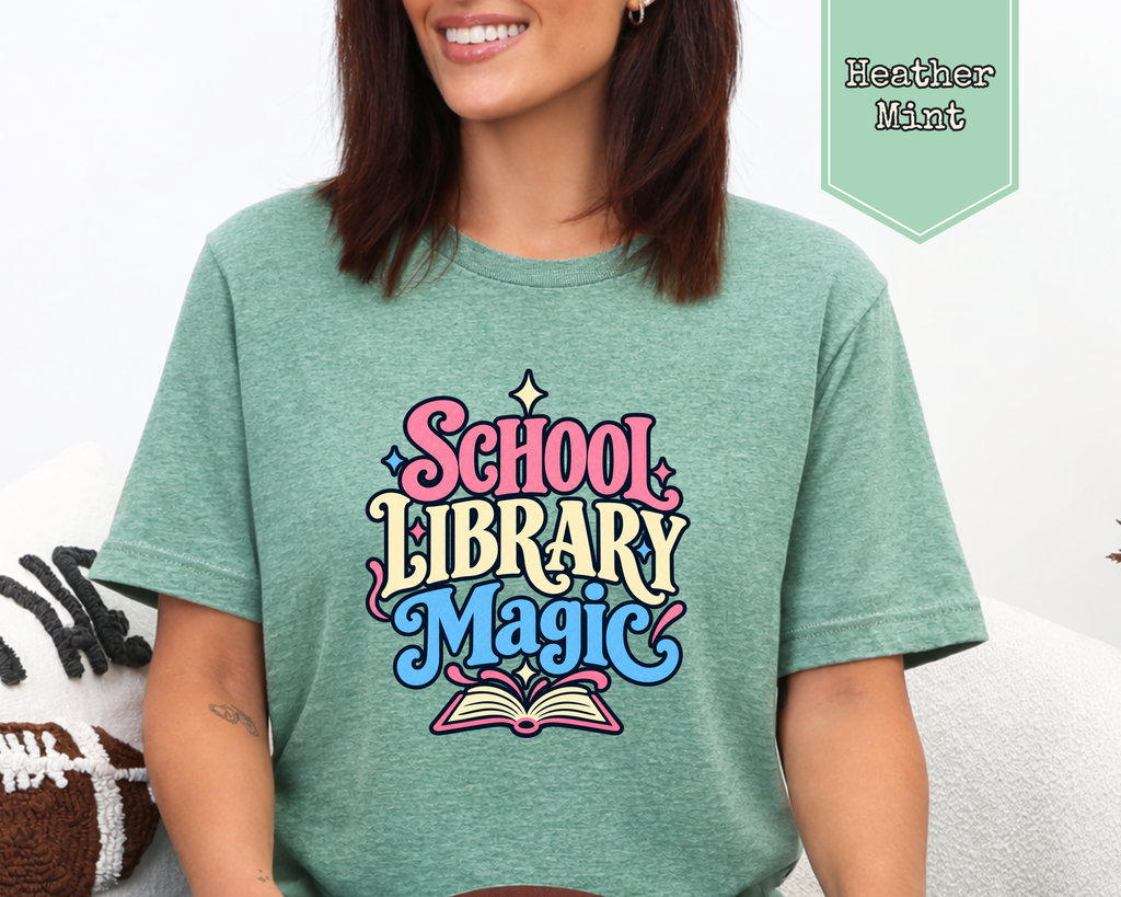 Model wearing White School Library Magic graphic tee featuring retro whimsical library artwork.