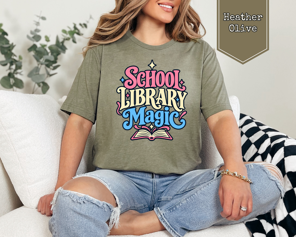 Person wearing Heather Prism Lilac School Library Magic unisex graphic t-shirt.