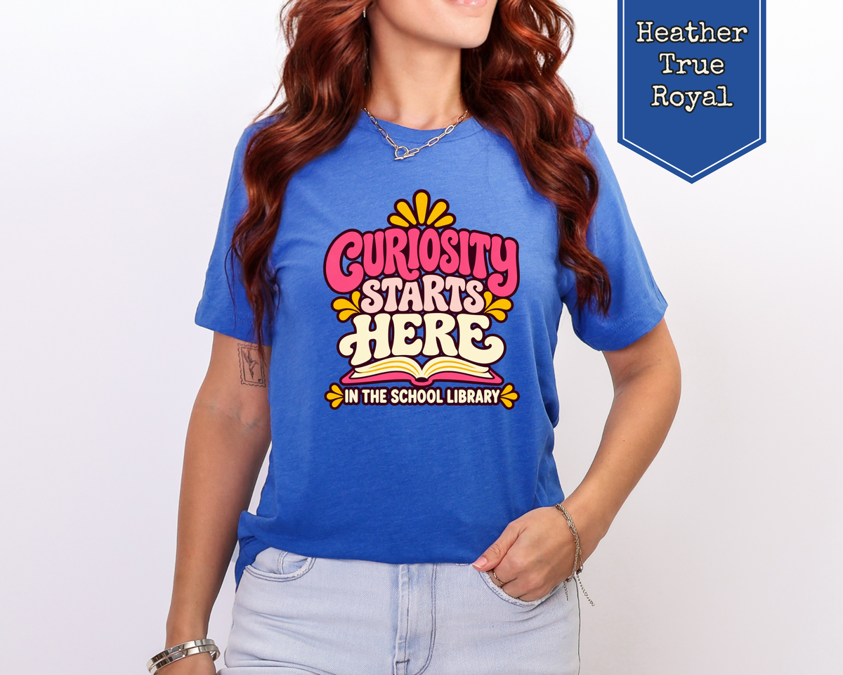 Model wearing Heather Olive Curiosity Starts Here retro librarian shirt.