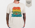 Woman wearing Heather Dust Good Things Grow in Libraries retro graphic tee with vintage typography and botanical illustration.