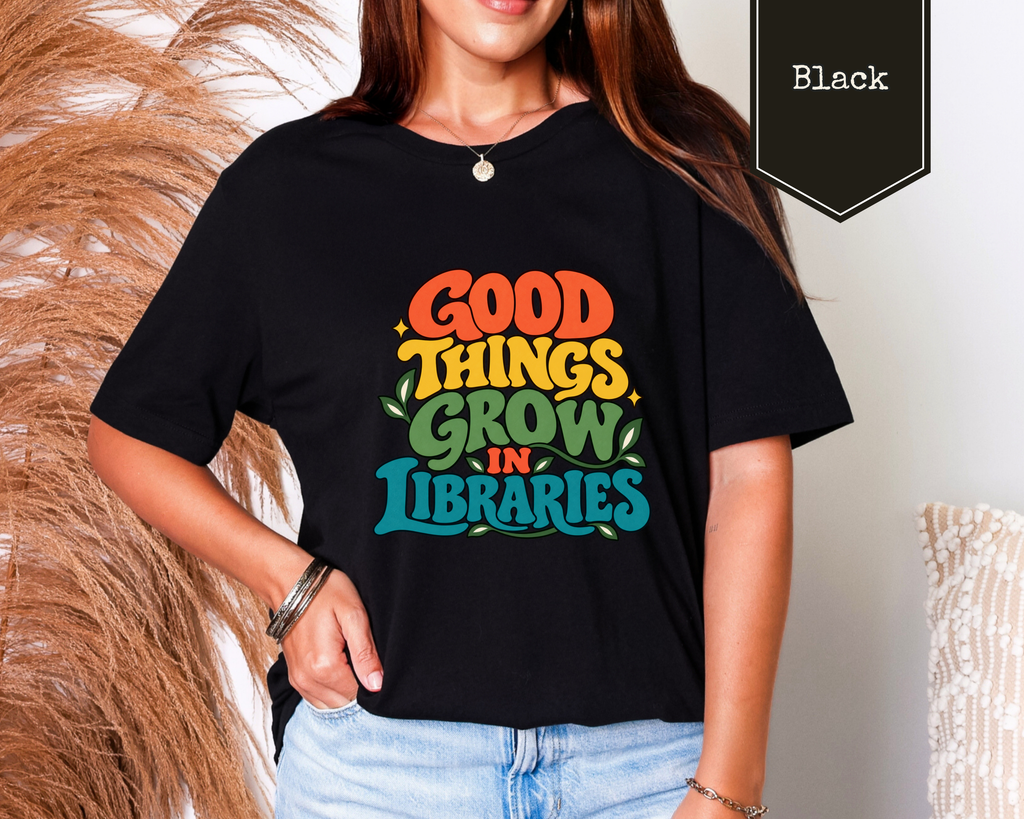 Man wearing Black Good Things Grow in Libraries librarian t-shirt featuring retro botanical bookish artwork.