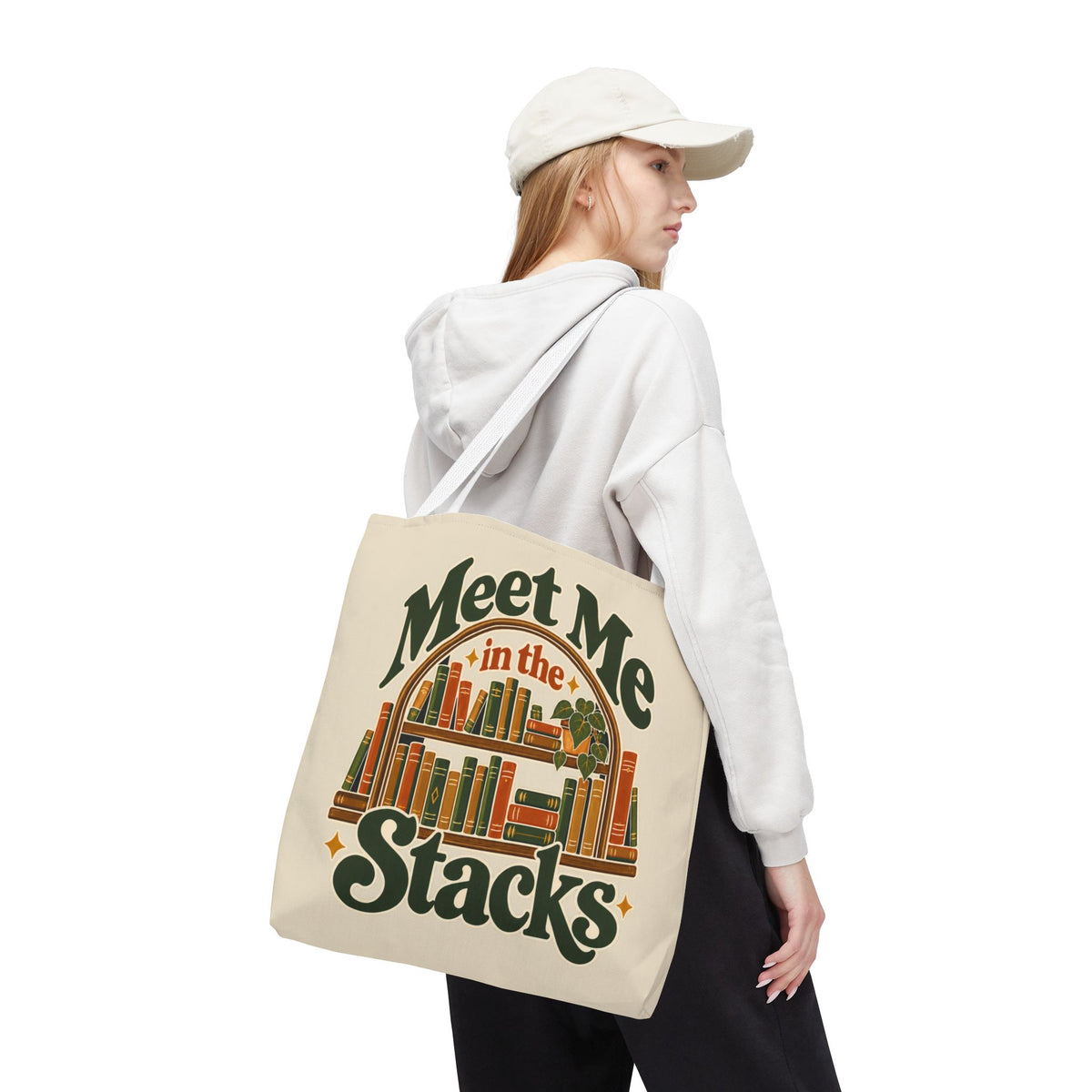 Meet Me in the Stacks tote bag in a cozy reading nook surrounded by houseplants.