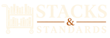 A logo-style graphic on a white background featuring a light cream book cart icon at left and the words 'STACKS & STANDARDS' in large cream and rust-brown lettering.